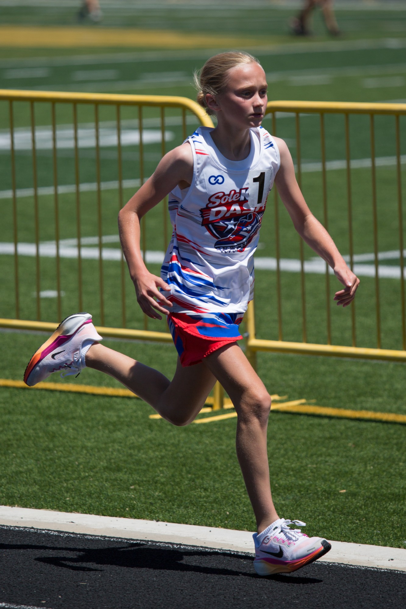 A DASH runner sprinting past the sideline in her team jersey