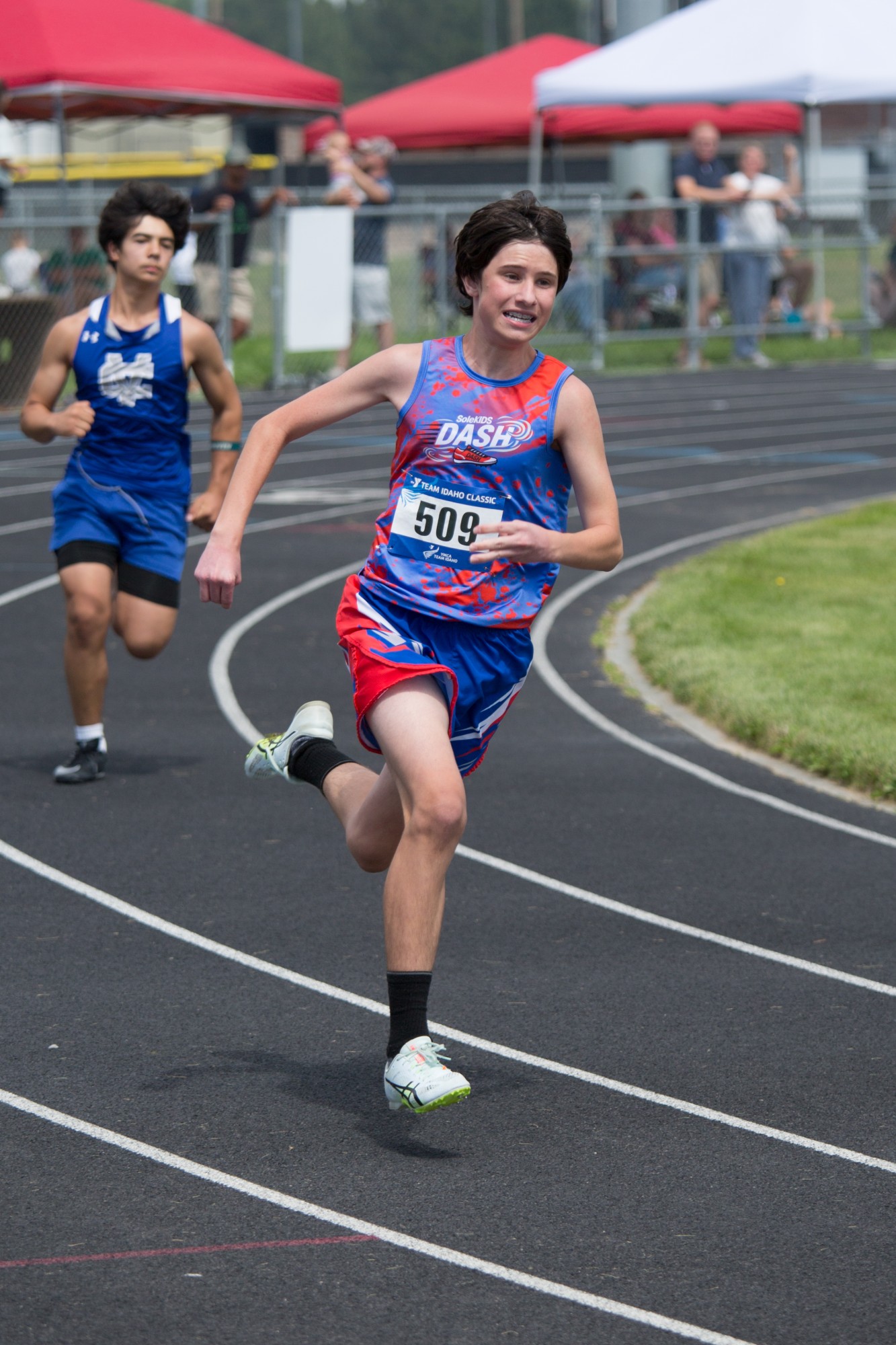 A DASH runner in a red and blue singlet racing ahead of another competitor